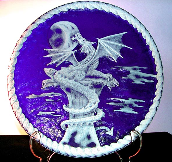 The Sentinel - By Sue Burne
It is a cameo engraving on a dark blue plate overlaid with white glass. So in other words everywhere that is blue or pale blue in the image has had the white overlay removed. This plate was blown for me especially and is lead crystal.
It is a drill engraving done with diamond burrs. Its diameter is 23 cm or about 9 inches.
