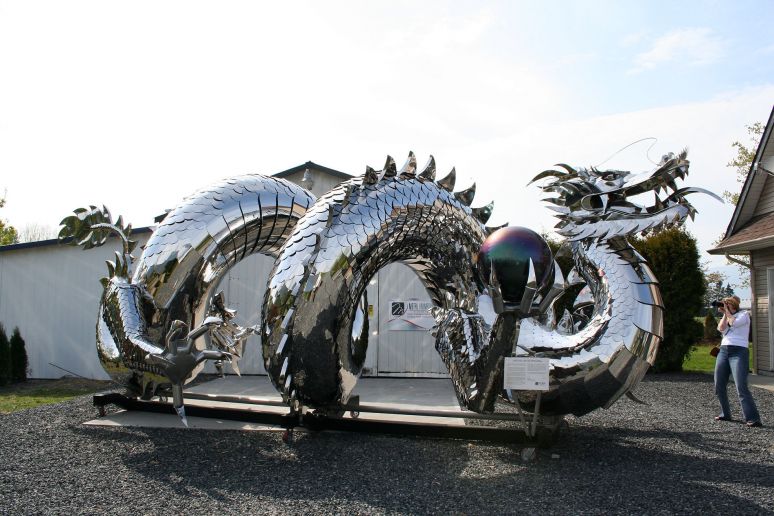 Chinese Imperial Water Dragon - By Kevin Stone
Metalanimation Studio Inc. Located in Chilliwack BC is pleased to announce the Public unveiling of local metal sculptor Kevin Stone.s 85 ft long , mirror polished stainless steel, Chinese "Imperial Water Dragon".

For almost 2 yrs, Kevin has been working 7 days a week, and is just now completing the final touches on what Kevin feels will be one of the greatest stainless steel sculptures to ever be unveiled anywhere in the world! Kevin has produced an exquisite world class sculpture with unsurpassed detail and on a scale and size of incredible proportions, Weighing 6000lbs and standing 12 ft high, 14 ft wide, 35 ft long with 2 large coils in the body. Stretched out Kevin's sculpture would be over 85 ft long!

