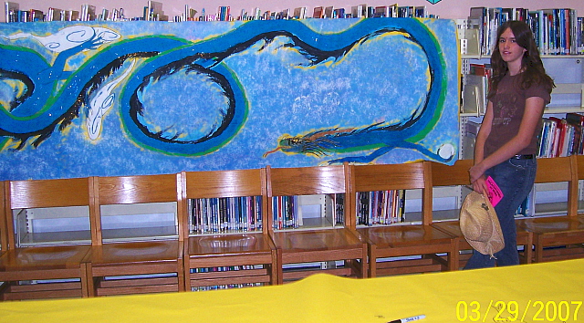 Pretty Drake - By Kelsey Kwolek
This took 2 weeks, its a dragon in a Japanese-ish style done in tempra paint on yellow paper. The full painting is about fifteen feet in length. Picture taken at my school.
