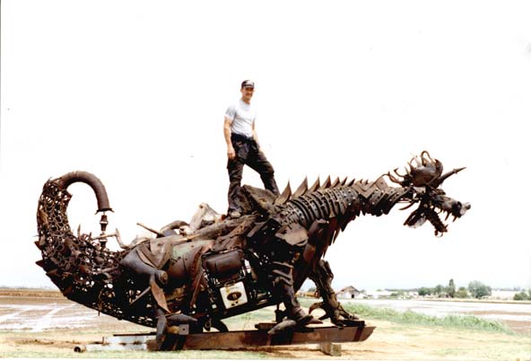 By Gabe Zanotto
The Dragon blows fire, moves his head up and down, sideways and slams his jaws!!  He operates on propane and an air compressor! The Dragon has a height of 12 feet, a length of 18 feet, a width of 9 feet,  a wing-span of 19 feet,  AND...Blows  his fire up to 10 feet!!  He loads up onto a 2 ton truck in ten minutes and unloads in under 20 minutes! He is for rent, for any event or party, but even if you dont need to rent him he is still something to see! 
