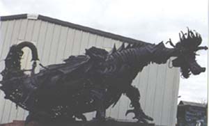 By Gabe Zanotto
The Dragon blows fire, moves his head up and down, sideways and slams his jaws!!  He operates on propane and an air compressor! The Dragon has a height of 12 feet, a length of 18 feet, a width of 9 feet,  a wing-span of 19 feet,  AND...Blows  his fire up to 10 feet!!  He loads up onto a 2 ton truck in ten minutes and unloads in under 20 minutes! He is for rent, for any event or party, but even if you dont need to rent him he is still something to see! 
