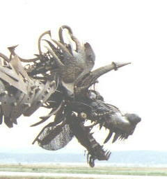 By Gabe Zanotto
The Dragon blows fire, moves his head up and down, sideways and slams his jaws!!  He operates on propane and an air compressor! The Dragon has a height of 12 feet, a length of 18 feet, a width of 9 feet,  a wing-span of 19 feet,  AND...Blows  his fire up to 10 feet!!  He loads up onto a 2 ton truck in ten minutes and unloads in under 20 minutes! He is for rent, for any event or party, but even if you dont need to rent him he is still something to see! 
